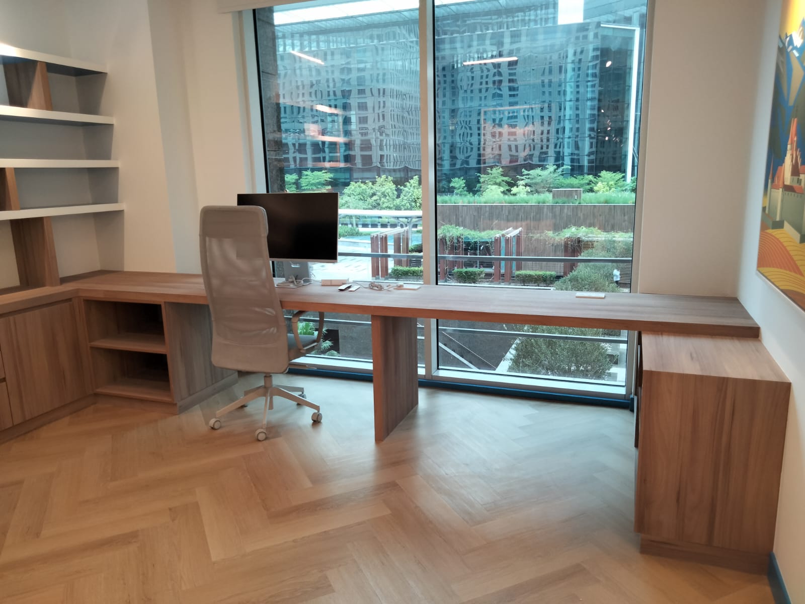 Installed bespoke office desk and shelving in wood veneer by Mistry Interiors, Dubai