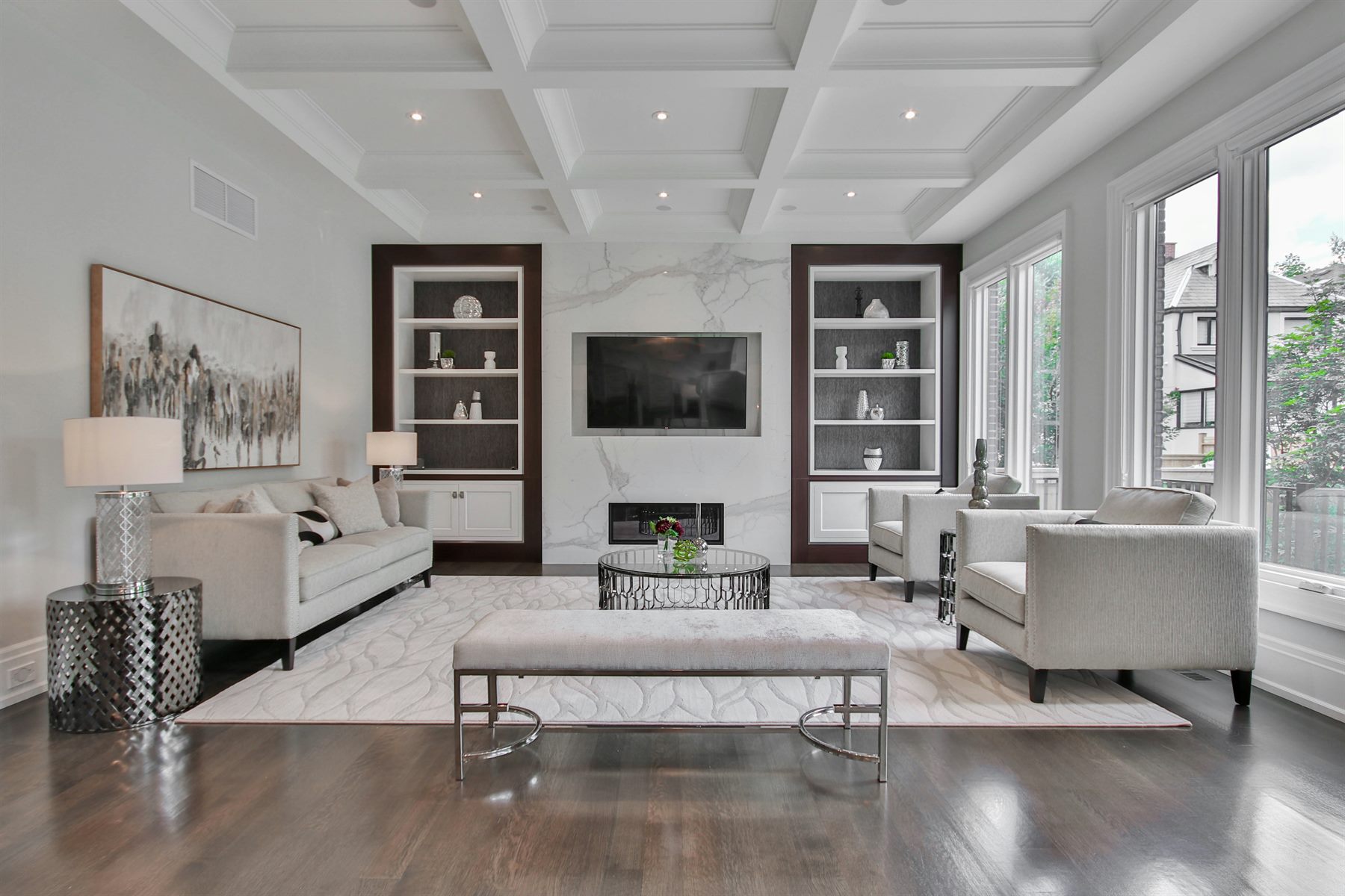 Coffered ceiling living room with built-in joinery and marble fireplace by Mistry Interiors