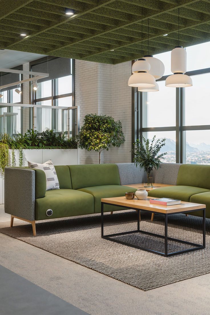 Corporate breakout lounge with acoustic ceiling, pendant lights and bespoke seating by Mistry Interiors